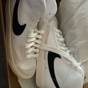 Nike White High-Top Sneakers with Black Swoosh